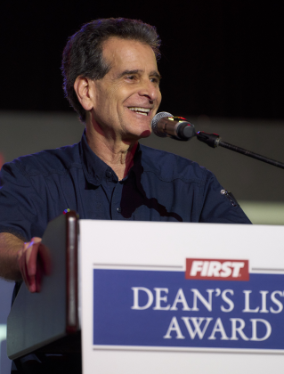 Dean Kamen stands giving a speech